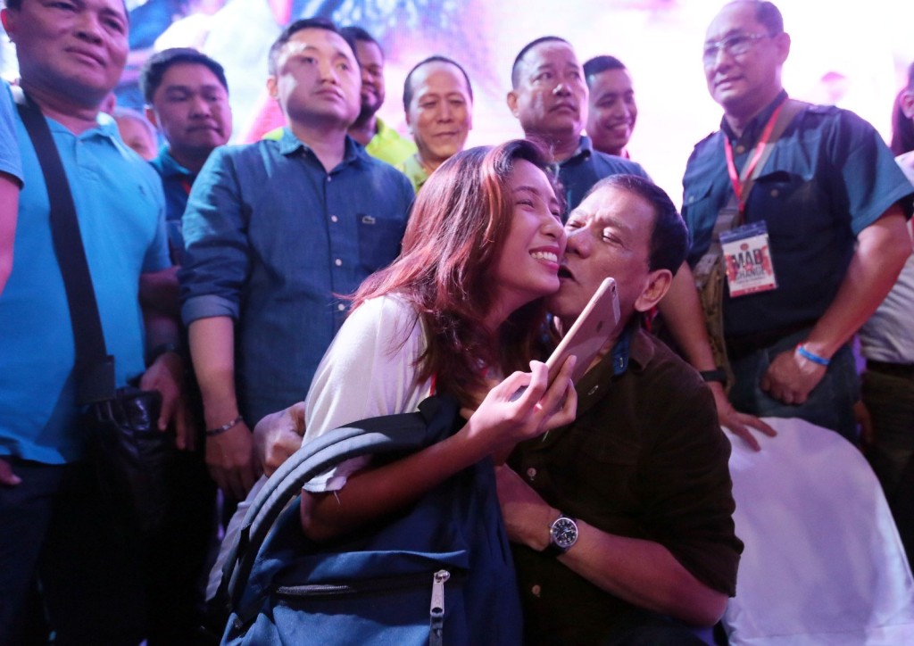 Presidential aspirant Rodrigo Duterte kisses a woman during his proclamation rally. GRIG MONTEGRANDE/PHILIPPINE DAILY INQUIRER